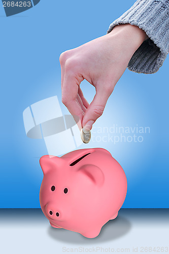 Image of Hand putting a coin euro