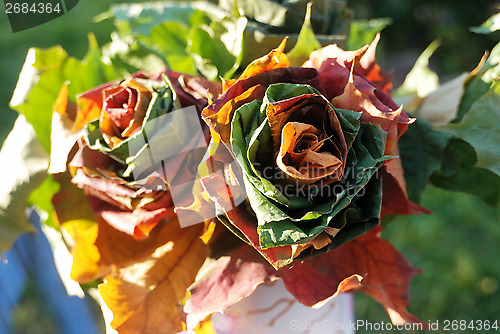 Image of two roses woven of fall leaves