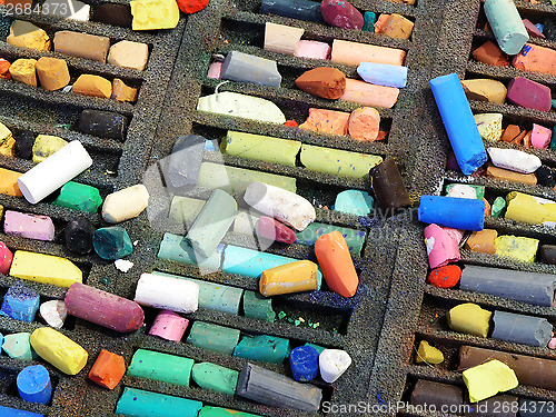 Image of pastel colored crayons in a box