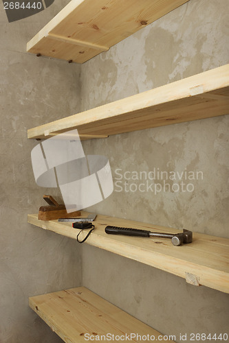 Image of Solid shelves made of wood in rural pantry