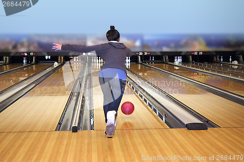 Image of Young girl playing bowling