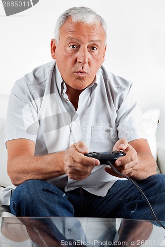 Image of Senior Man Playing Video Game