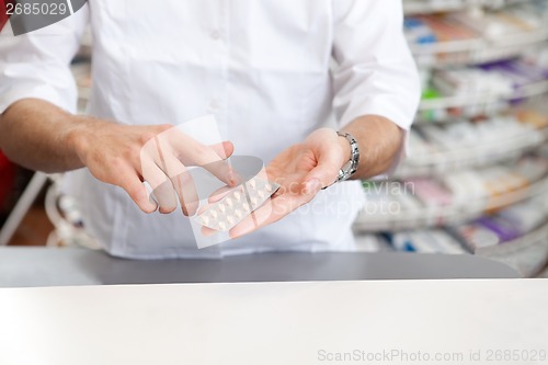 Image of Male Pharmacist Giving Prescription Medicine