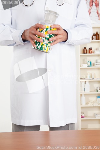 Image of Doctor Holding Pills Bottle