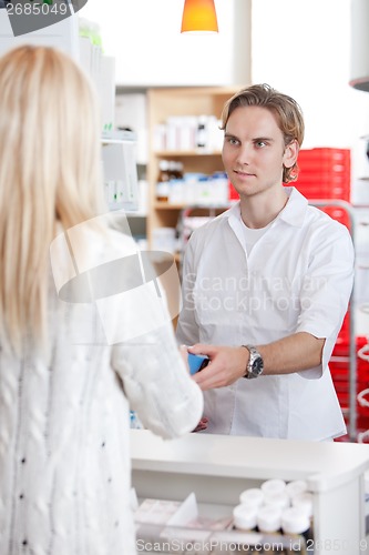 Image of Male Pharmacist With A Customer In Pharmacy