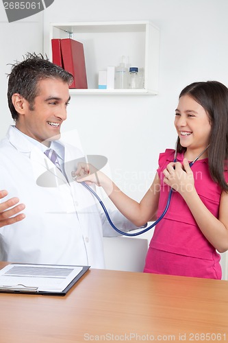 Image of Child Examining Male Doctor