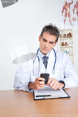 Image of Male Doctor Using Mobile Phone