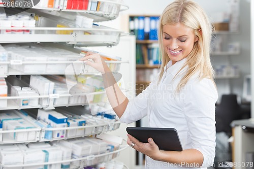 Image of Female Chemist Standing in Pharmacy Drugstore