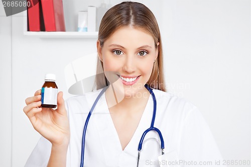 Image of Doctor Holding Medicine Bottle