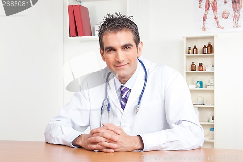 Image of Male Doctor Sitting at Desk