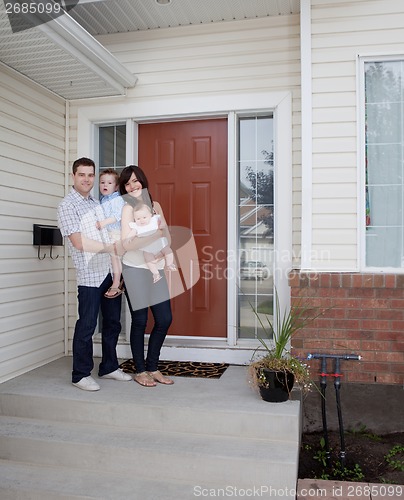 Image of Young Family in Front of House