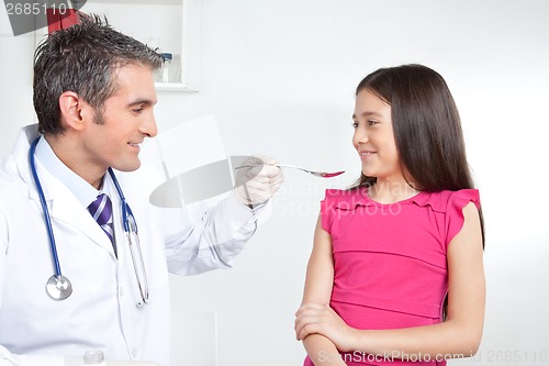 Image of Doctor Giving Medicine to Girl