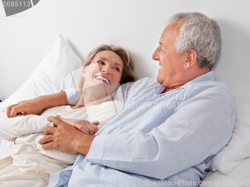 Image of Couple Relaxing in Bed