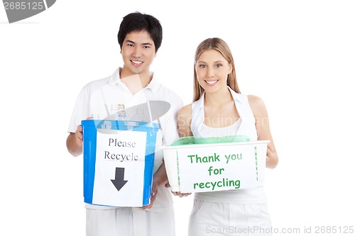 Image of Young Couple  Holding Recycle Bin