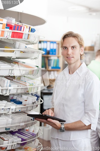 Image of Portrait Of Male Pharmacist Holding Tablet Pc