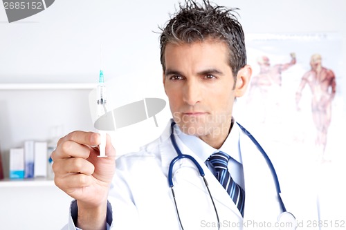 Image of Male Doctor Looking at Syringe