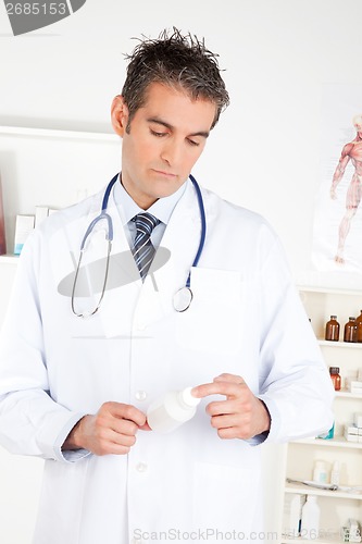 Image of Doctor Holding Pills Bottle