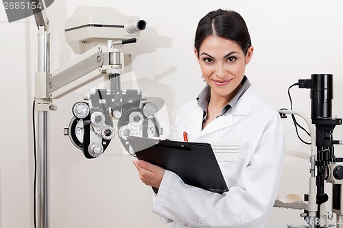 Image of Smiling Young Optometrist With Clipboard