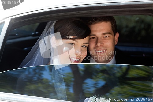 Image of Wedding Couple in Limousine