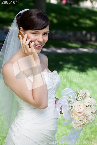 Image of Happy Bride Using Cell Phone