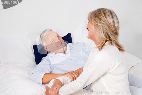 Image of Couple Relaxing in Bed