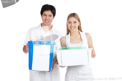 Image of Young Couple  Holding Recycle Bin