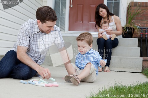 Image of Father and Son Playing on Sidewalk