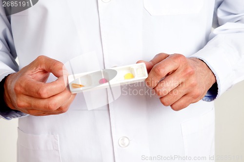 Image of Male Doctor Hand Holding Pills