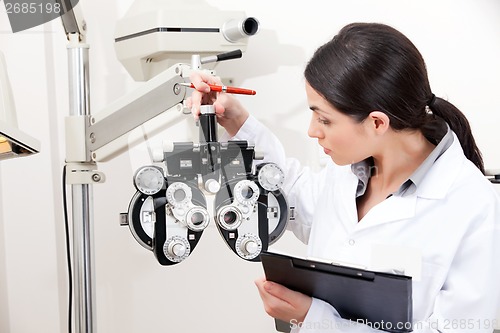 Image of Optometrist Looking at Phoropter