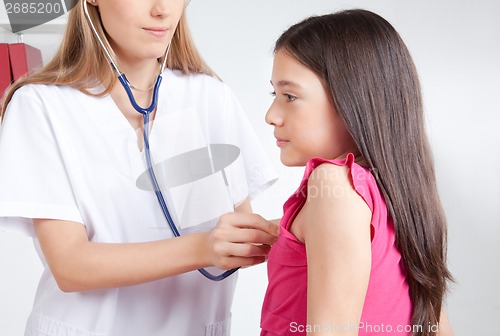 Image of Doctor Examining Child in Clinic