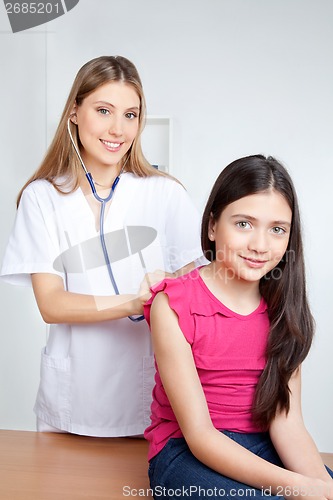 Image of Doctor Examining Child in Clinic