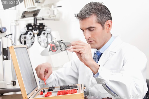 Image of Optometrist Holding Measuring Eye Glasses