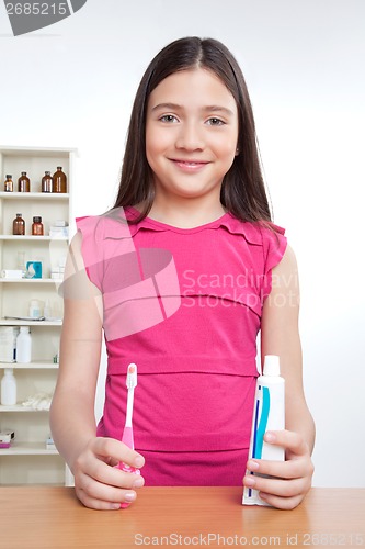 Image of Girl Holding Toothbrush and Tooth Paste