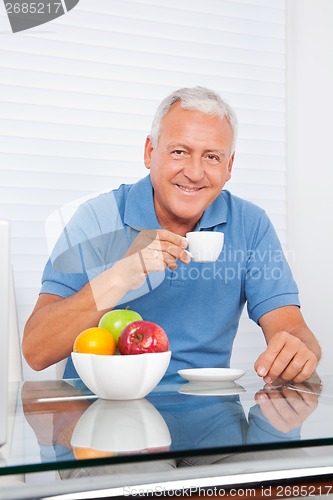 Image of Senior Man Having Cup of Tea