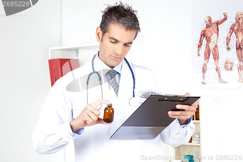 Image of Doctor Holding Clipboard and Bottle