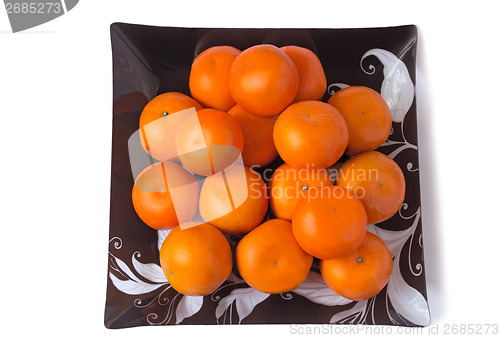 Image of Large ripe tangerines in a glass dish on a white background.