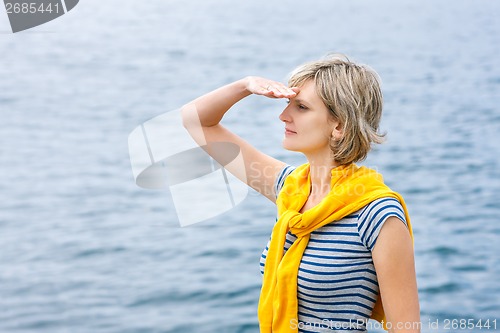 Image of Middle age woman outdoors  looking in distance