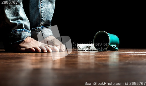 Image of Feet in front of dropped cup