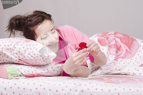 Image of Girl in bed happy donated rings