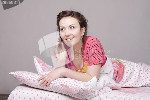 Image of girl smiles talking on phone