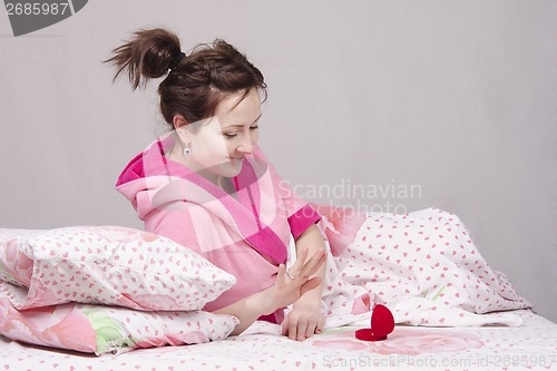 Image of Girl in bed rejoices presented to the ring