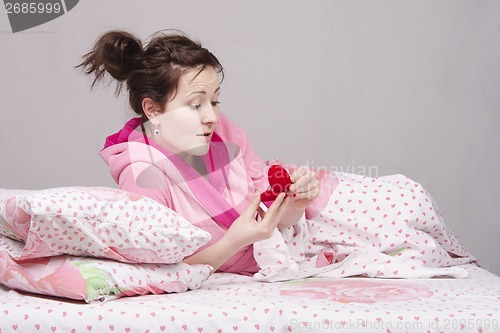 Image of Girl in bed surprised donated ring