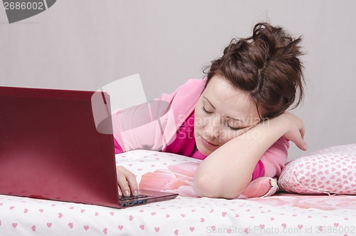 Image of Girl in bed asleep for a laptop