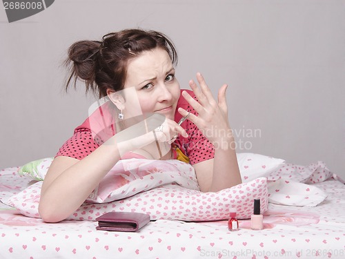 Image of girl tries to cut off finger nail scissors