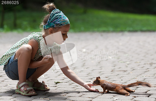 Image of Little girl and squirrel