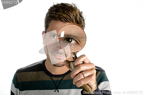 Image of Man looking through magnifying glass