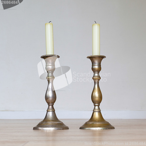 Image of Burning candle on wooden table