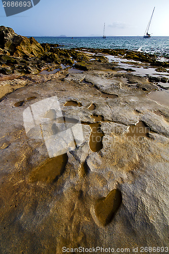 Image of beach  boat yacht  lanzarote  spain coastline rock  water  and s