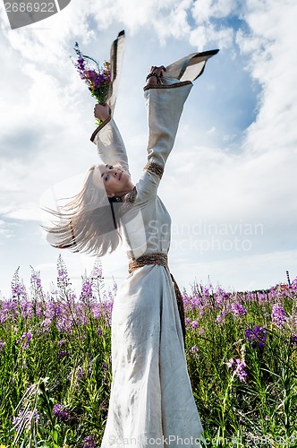 Image of Beautiful woman relaxing with flowers