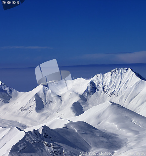 Image of View on off-piste snowy slope at nice sunny day